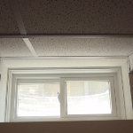 Picture of finished suspended ceiling window well slope in basement